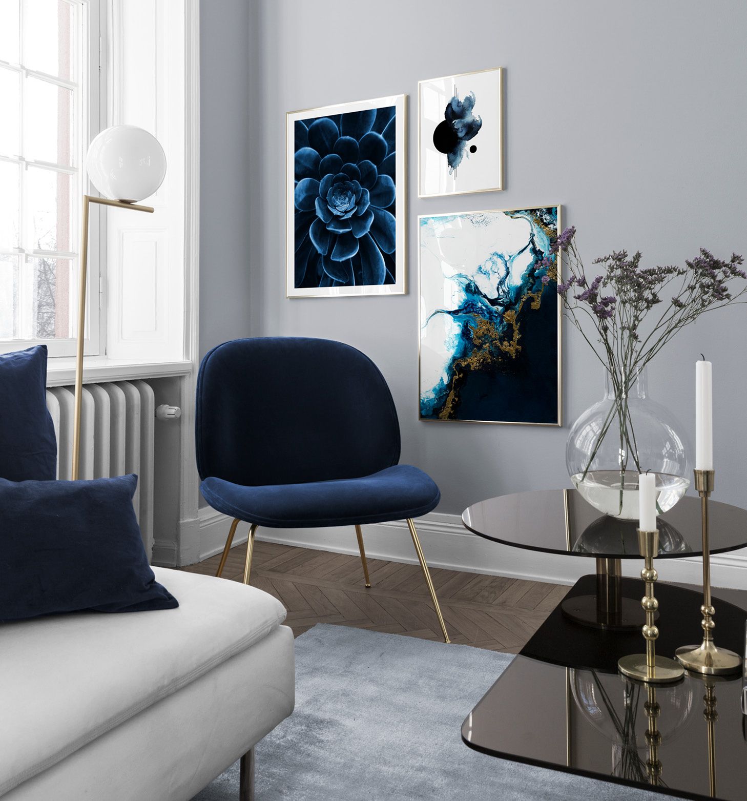 Blue interior living room – abstract posters and chair from Gubi