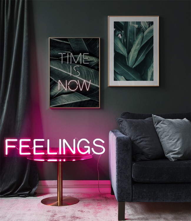 Dark interior with text poster ‘time is now’, palm posters and neon sign
